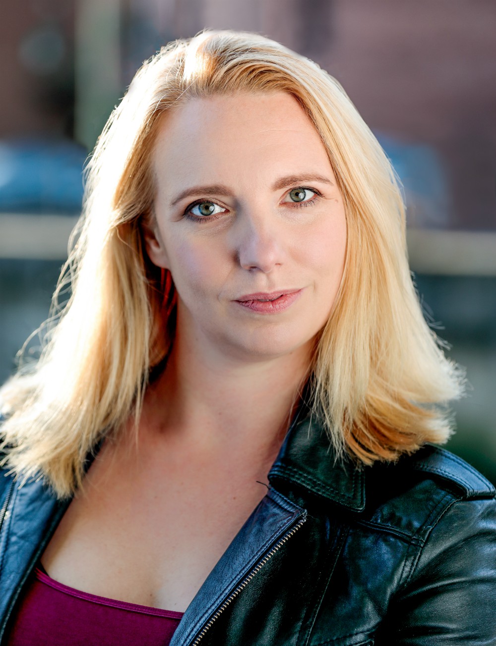 Colour studio shot of Gillian Dean outdoors wearing a leather jacket
